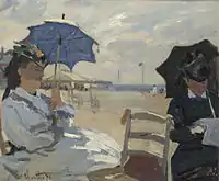 La plage de Trouville, 1870, National Gallery, London. The left figure may be Camille, on the right possibly the wife of Eugène Boudin, whose beach scenes influenced Monet.