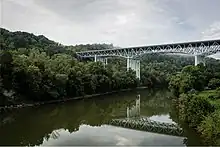 Modern bridge spanning the Kentucky River, well above the river's surface.