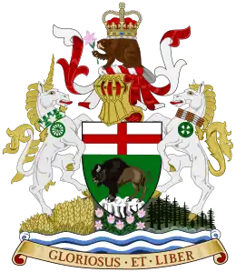 A central shield showing a bison standing on a rock, under a St George's Cross. On top of the shield sits a helmet decorated with a red and white billowing veil. On top of the helmet sits a beaver with a crown on its back, holding a prairie crocus. To the right of the shield is a rearing white unicorn wearing a collar of white and green maple leaves, from which hangs a green cart-wheel pendant. To the left of the shield is a rearing white horse wearing a collar of Indian beadwork, from which hangs a green cycle of life medallion. The animals and shield stand on a mound, with a wheat field beneath the unicorn, prairie crocuses beneath the shield, and spruces beneath the horse. Beneath the mound are white and blue waves, under which is an orange scroll bearing the words "GLORIOSUS ET LIBER"