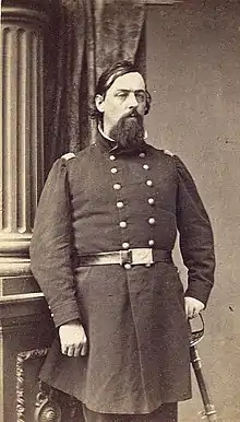 American Civil War officer with long goatee standing with sword