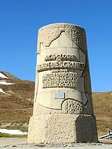 Upright cylindrical monument with an inscription inside the outline of France