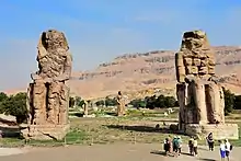 Two huge statues of seated figures