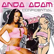 Anda Adam is shown wearing pink shorts and a crop top. Next to her, a cartoonified version of Anda having a similar pose can be seen. CDs and Vinyls can be spotted in the white and pink background.