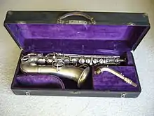 A straight-necked Conn C melody saxophone dated 1922. Rolled tone holes are visible on the bell
