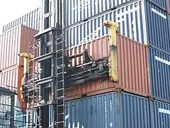 Skystacker attaching to just two top corner castings on one side of 20-foot container