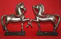 A pair of silver horses on green marble bases by Renato Signorini.