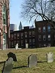 The Copp's Hill Burying Ground in the foreground with the Custom House Tower and One International Place glimpsed in the background.