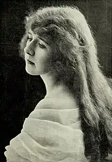 A young white woman with long hair, shown loose down her back.