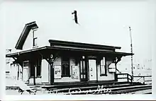 A black-and-white postcard of a small railway station