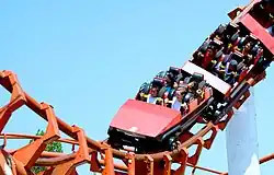 Photograph of a red roller coaster performing a loop.