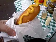 A corn dog with mustard