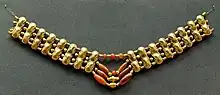 Necklace with gold beads and carnelian beads, Cypriot artwork with Mycenaean inspiration, c. 1400–1200 BC.[citation needed] From Enkomi. British Museum.