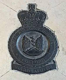A metal relief of a Royal Air Force Badge set into marble on a floor