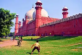 Locals playing tape ball cricket near Badshahi Masjid, Pakistan