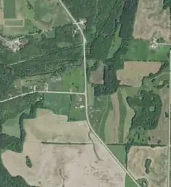 Ryans Corner on August 7, 2020. County Trunk Highway A (left) and County Trunk Highway C make a T-intersection. The Kewaunee River is visible to the north of Ryans Corner, and the Ahnapee State Trail is visible to the north of the river.