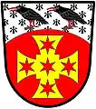 Gules, a cross paty quadrate or, charged with five mullets of six points gules: a chief arched ermine charged with two Cornish choughs proper - Vickers, England