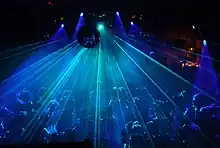 Crowd of dancers under a disco ball and laser light show