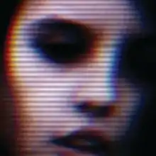 A blurry close up of a face with a scan line effect.