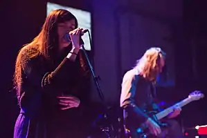 Madeline Follin and Brian Oblivion performing in 2014