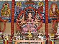 Cundi, flanked by devas, and with Bhaisajyaguru Buddha (left) and Amitabha Buddha (right). The Chinese text on the front of the altar reads, Namo Zhunti Wang Pusa, or "Namo Cundi King Bodhisattva." Statue located at a Chinese Buddhist temple in Kelantan, Malaysia.