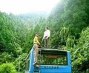 Curious Tourist on the Roof of NBSTC Bus at Lava