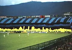 Chroreography, including a large black-and-blue striped flag, on display at the Curva Nord during an Atalanta match
