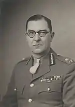 bespectacled man in the uniform of a major-general of the British army facing the camera