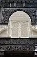 Stucco and wood carvings on one of the lateral galleries of the courtyard