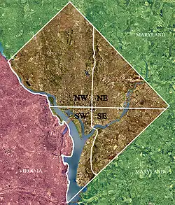 Color-enhanced USGS satellite image of Washington, D.C. with the crosshairs marking the quadrant divisions of Washington, D.C., with the U.S. Capitol at the center of the dividing lines. To the west of the Capitol extends the National Mall, visible as a slight green band in the image. The Northwest quadrant is the largest, located north of the Mall and west of North Capitol Street.