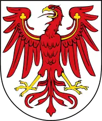 Argent, an eagle displayed gules armed and wings charged with trefoils Or. Arms of Brandenburg.