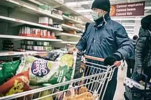 Shoppers in London panic buying canned food and toilet paper during the COVID-19 pandemic