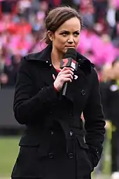 Pearce holding a microphone