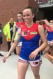 Pearce walking out of her team's changerooms followed by her teammates