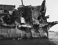 View of the USS Independence's port quarter showing severe blast damage caused by the "Able Day" atomic bomb air burst over Bikini Atoll on July 1, 1946