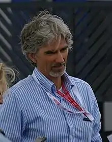Damon Hill walking to the left of the camera