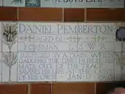 A tablet formed of five tiles of varying sizes, bordered by yellow and blue flowers in an art nouveau style