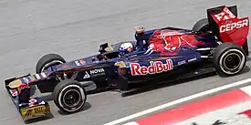 Sponsorship from Falcon Bank brought more gold to the team's livery. This is Daniel Ricciardo driving the STR7 at the 2012 Malaysian Grand Prix.