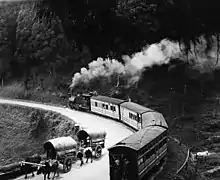 Steam passenger train rounding a curve