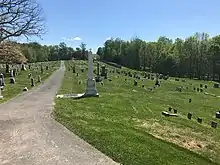 big cemetery in field with walkway in middle