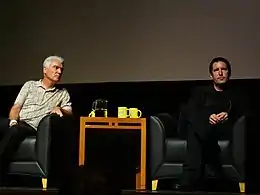 Reznor (right) discussing his return to major labels at an October 2012 panel with David Byrne