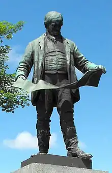 Statue of David Davies, holding the plans for Barry Docks, at Llandinam