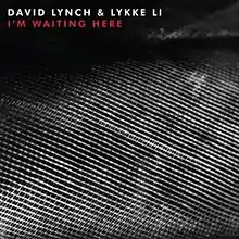 A black-and-white image of a sewn texture. White and red text above reads "David Lynch and Lykke Li I'm Waiting Here".