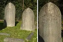 Two granite headstones in a grassy cemetery