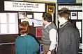 David W. Hughes explaining the images of the nucleus of P/Halley to final year BSc Combined Honours Physics and Astronomy students. Taken at the 1989 research bazaar, Hicks building.