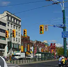 Traffic signals at Spadina Avenue and Dundas Street in Toronto, Canada; the black signal in the median is for transit streetcars