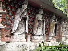 Southern Song Dynasty (1127–1279 CE) cliff carving of Vairocana (centre), with Manjushri (left), and Samantabhadra (right) among the Dazu Rock Carvings at Mount Baoding, Dazu District, Chongqing, China.