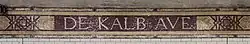 A tile mosaic at the station, with the name "De Kalb Ave" in capital letters.