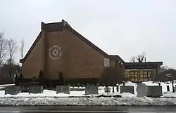 The Synagogue of Deal with the front lawn covered by snow.
