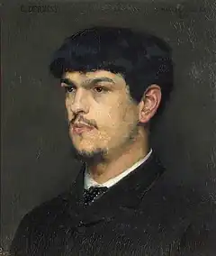 head and shoulder, semi-profile of young man with dark hair, combed forward into a fringe; he has a small beard