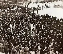 photograph of crowd around flag raising
